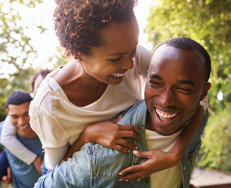 Cheerful young couple having fun outdoors and laughing. Cheerful young couple having fun outdoors and laughing.