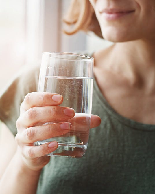Women holds glass of water