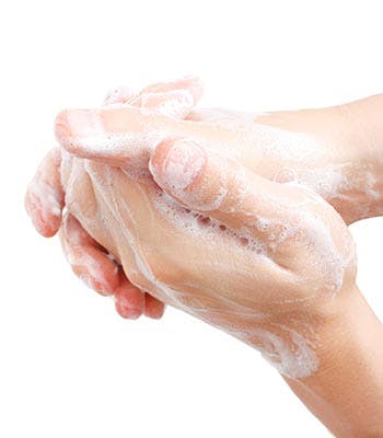 Washing hands with warm soapy water