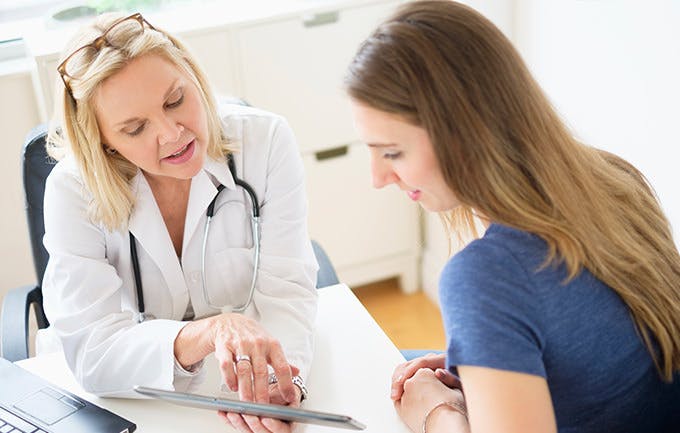 Doctor Talking To Patient In Office