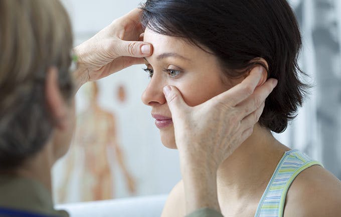 Woman Getting A Check Up From Doctor