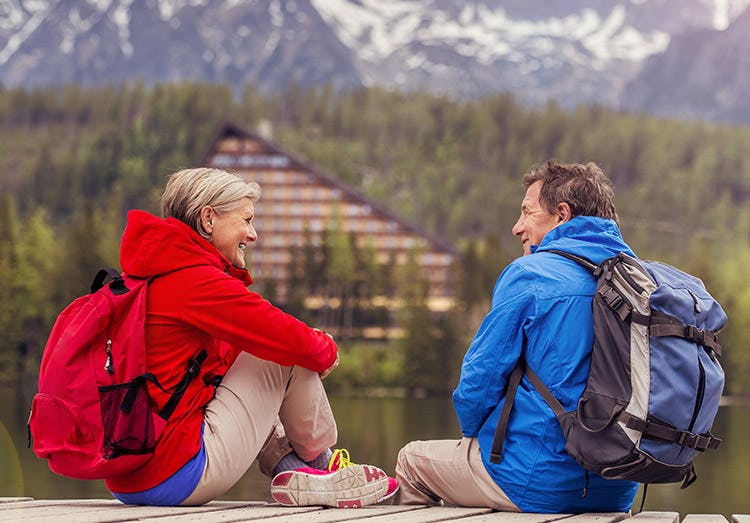 Senior Hikers Couple During The Walk Round The Tarn In Beautiful Mountains Hills Senior Hikers Couple During The Walk Round The Tarn In Beautiful Mountains Hills