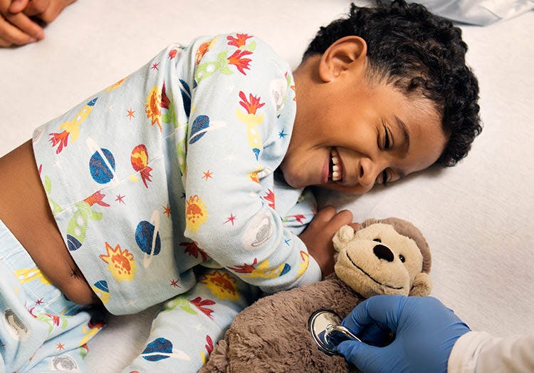 Doctor Examining The Toy Of A Little Boy Doctor Examining The Toy Of A Little Boy