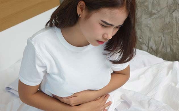 Woman experiencing abdominal pain