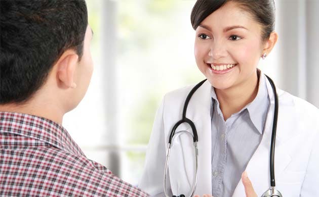 Doctor Talking To Patient In Office