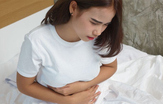 Woman experiencing abdominal pain