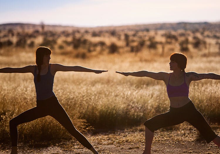 Dos mujeres haciendo yoga al aire libre
