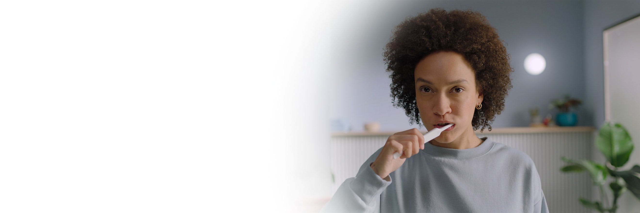 A woman brushing her teeth.