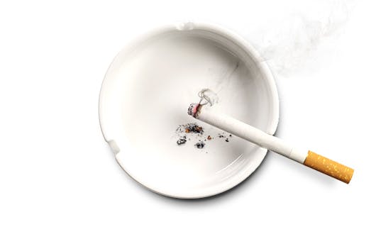 Lit cigarette in ashtray