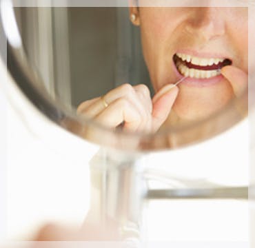 Flossing Teeth In Mirror