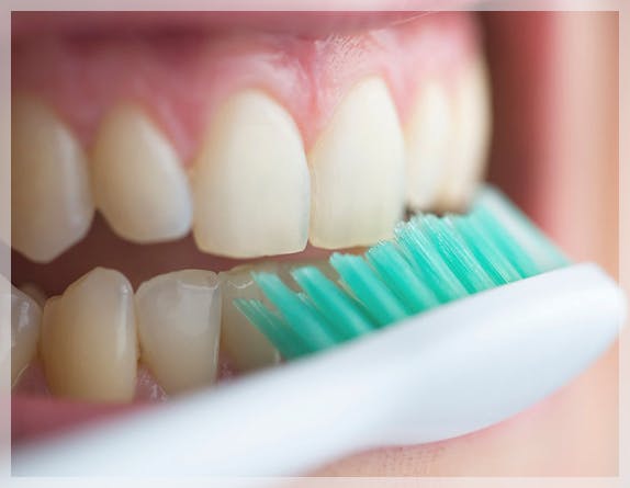 Woman brushing teeth