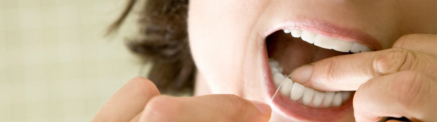 Woman flossing her teeth