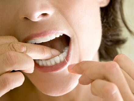 Woman flossing her teeth