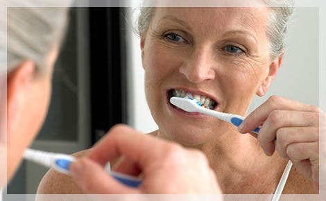 Elderly Woman Brushing Teeth Plaque Build Up parodontax