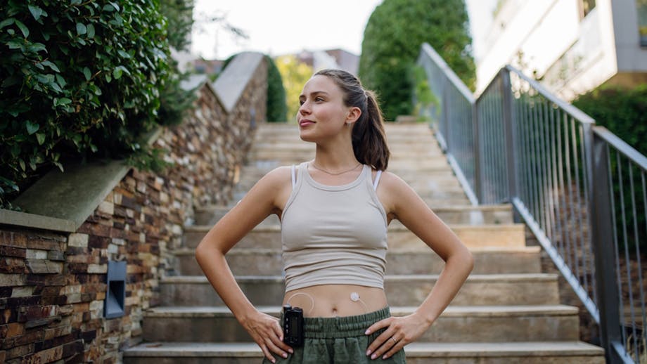 Woman standing in front of stairs with hands on her hips