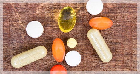 An assortment of vitamins displayed on a wooden surface