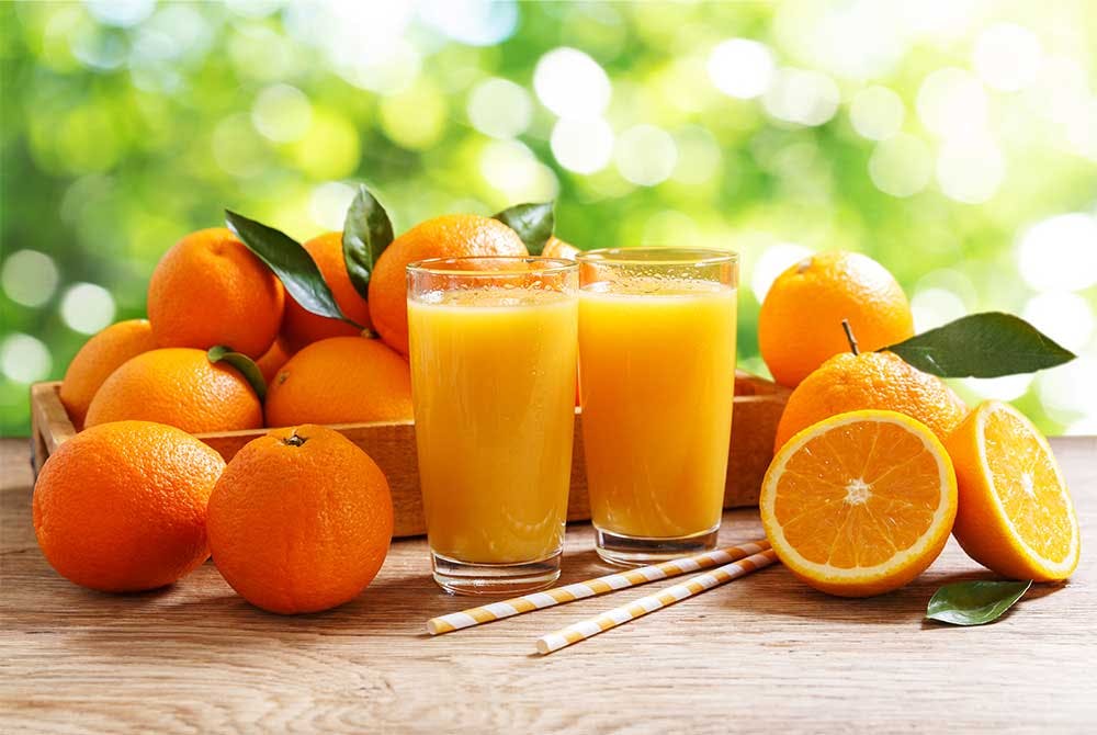 Oranges and orange juice on outdoors table