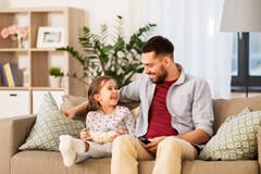 Father and daughter talking on a sofa Father and daughter talking on a sofa