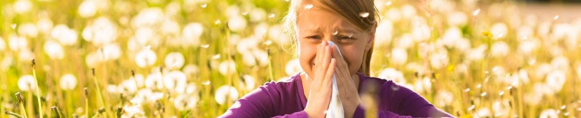 Girl outside blowing nose, hay fever Girl outside blowing nose, hay fever