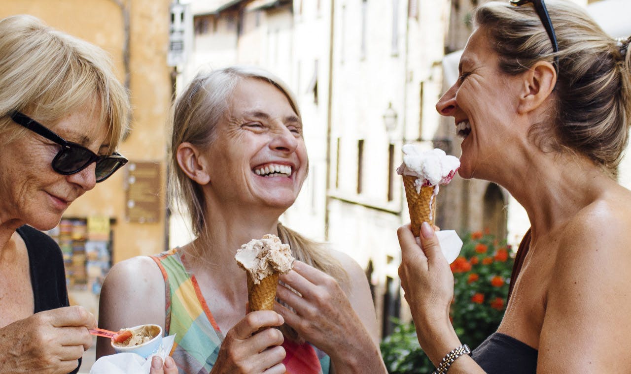 three women eating ice cream three women eating ice cream