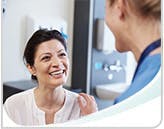 Smiling woman talks to a dental professional
