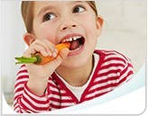 Young girl eating a carrot