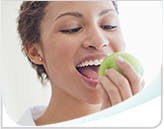 Woman eating a green apple