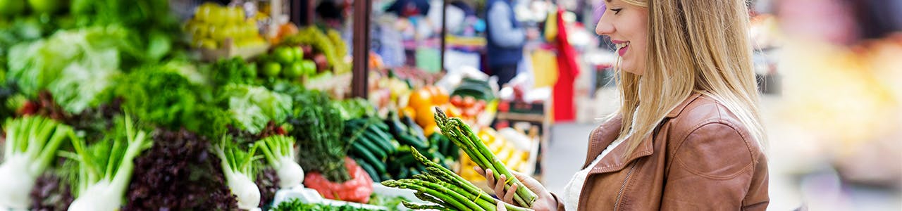 Woman with a White Smile Picking Vegetables Header