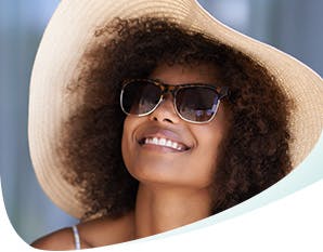 Woman Smiling with White Teeth Wearing Hat Sunglasses Thumbnail