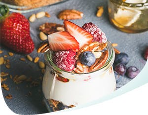 Jar of parfait with yogurt, granola and acidic fruits