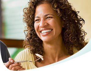 Smiling Woman Enjoying a Meal