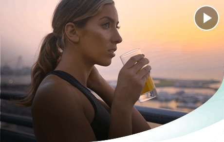 Woman Listening to Music Holding Orange Juice