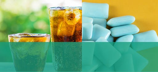 Two glasses of acidic pop beside sugar free gum