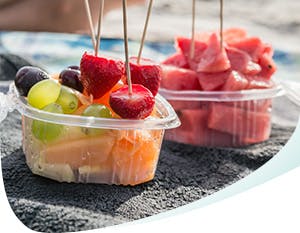 Two bowls filled with acidic fruits: strawberries, grapes, watermelon