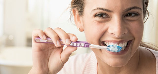 Woman Brushing Teeth Header Mobile