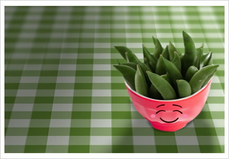 Snap peas snack in a pink bowl with a smile drawn on it