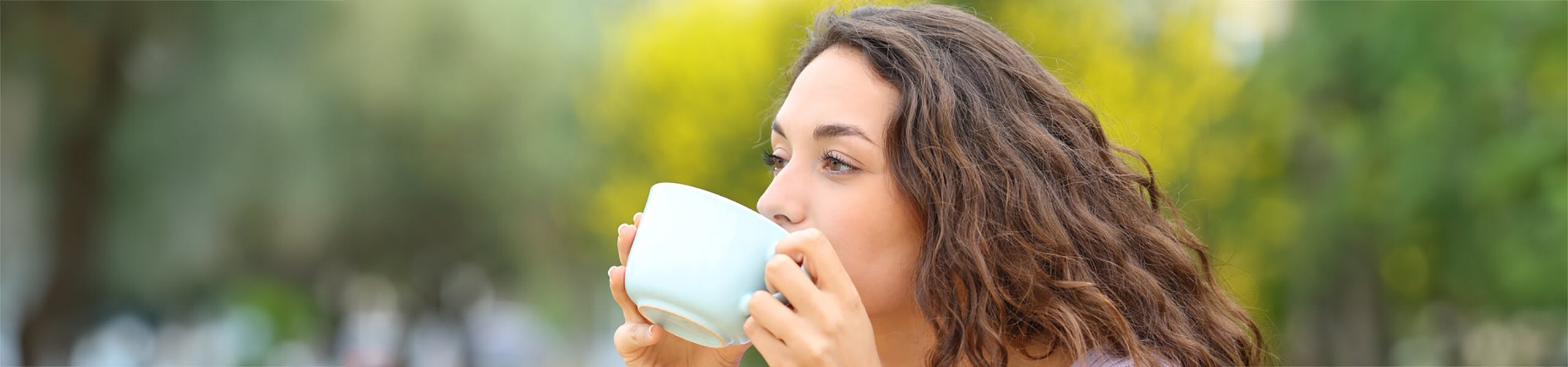 A woman drinking from a mug