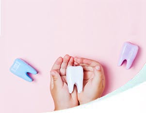 Child’s hand holding a tooth