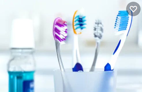 Toothbrush and toothpaste in a glass container