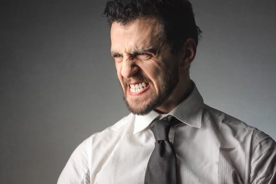 Businessman grinding his teeth