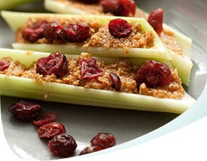 Celery topped with peanut butter and raisins