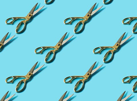 Hair-cutting scissors in a repeating pattern.