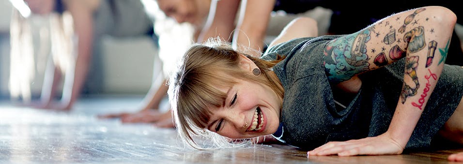 Woman laughing while doing yoga Woman laughing while doing yoga
