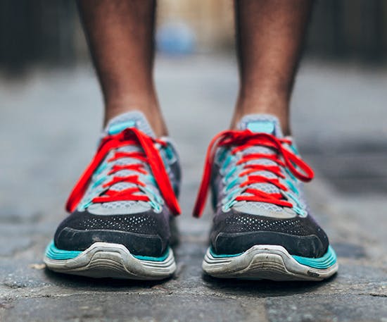 Man’s feet in colourful running shoes Man’s feet in colourful running shoes