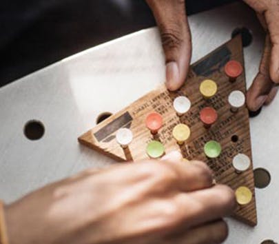 Hands doing a cognitive puzzle on a table Hands doing a cognitive puzzle on a table