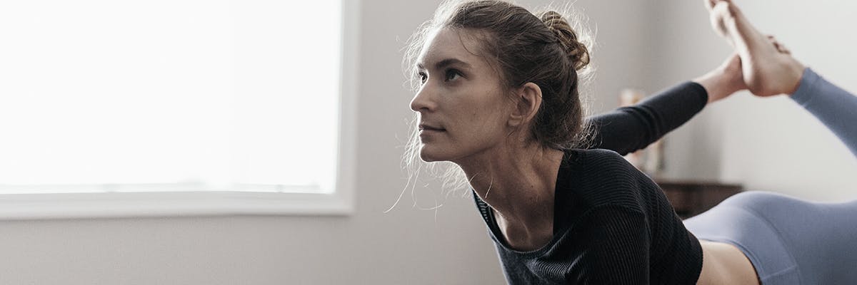 Une femme pratiquant le yoga dans une pièce calme