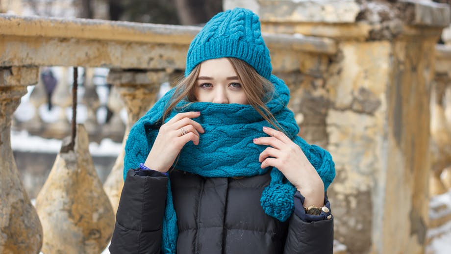 Woman with blue scarf around her mouth