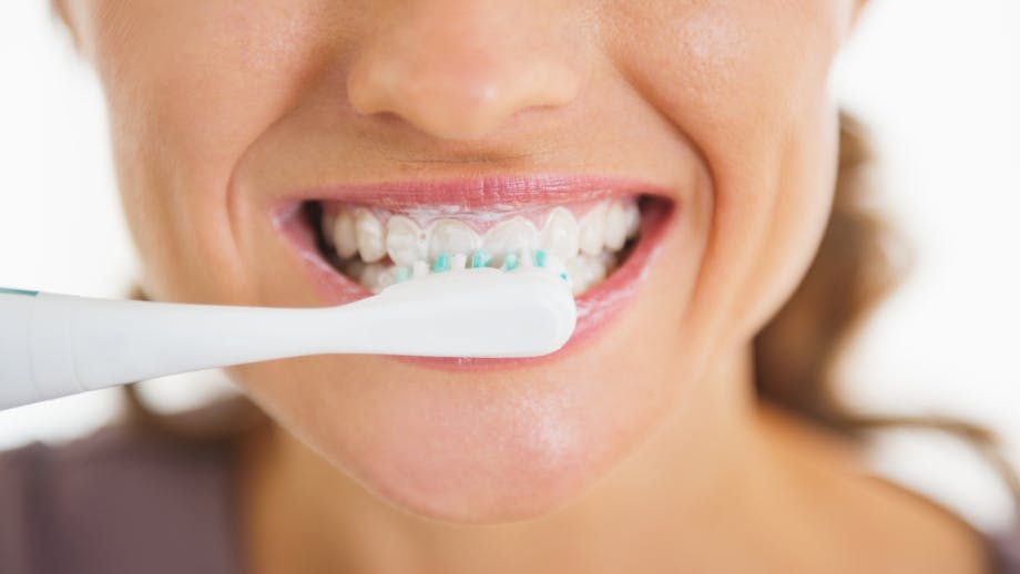 Close up of woman brushing teeth