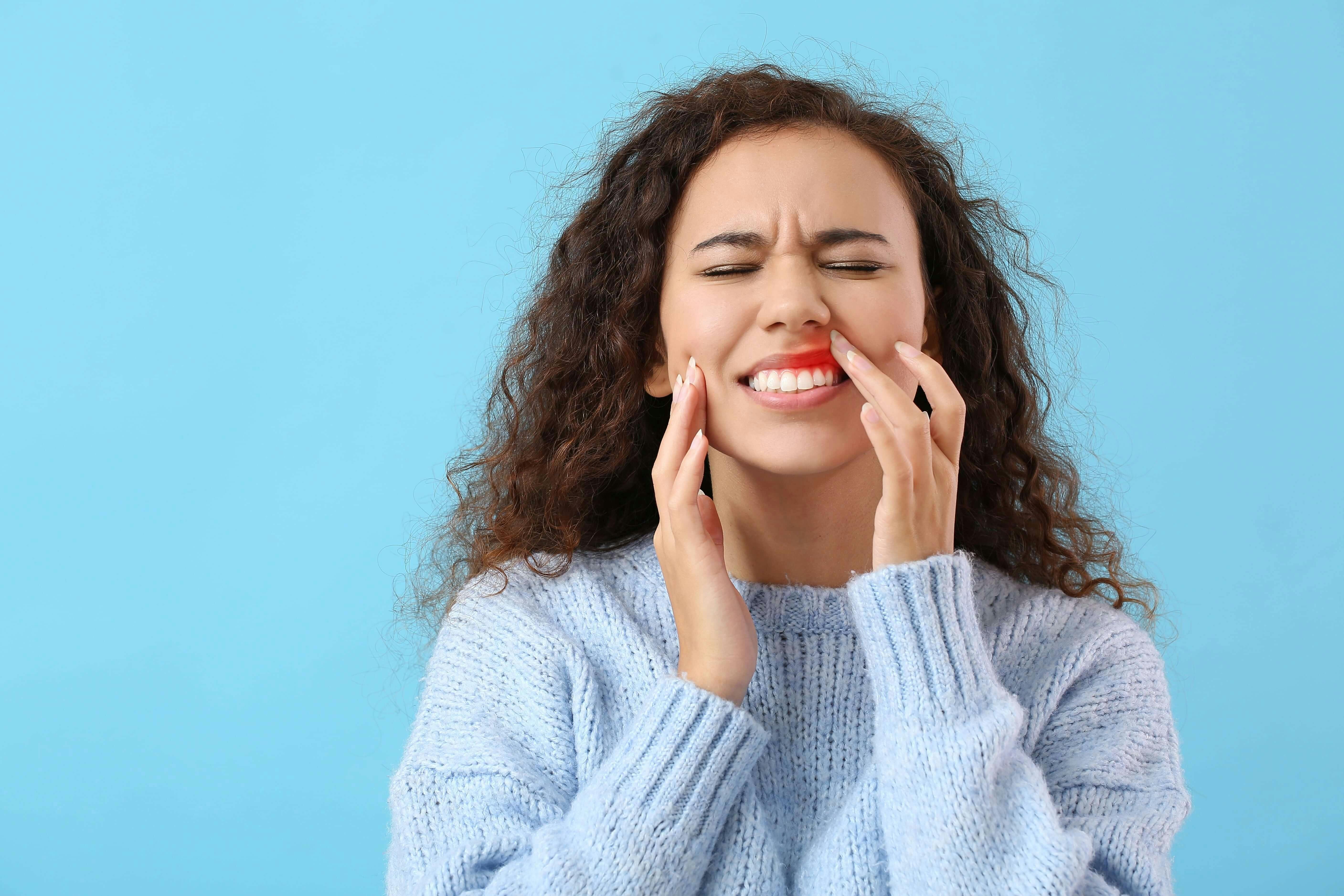 Young African American woman suffering from gum disease