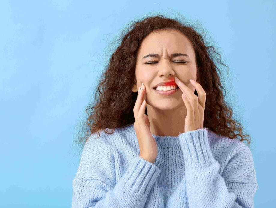 Young African American woman suffering from gum disease